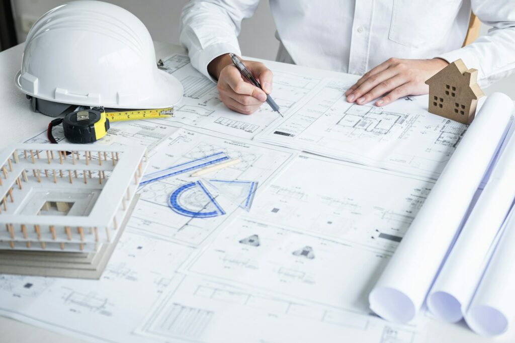 Construction engineering or architect hands working on blueprint inspection in workplace